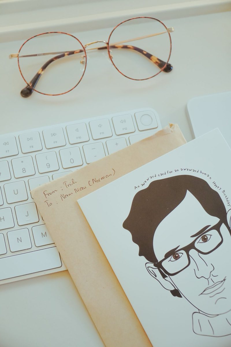 A workspace with eyeglasses, a hand-drawn sketch and a keyboard